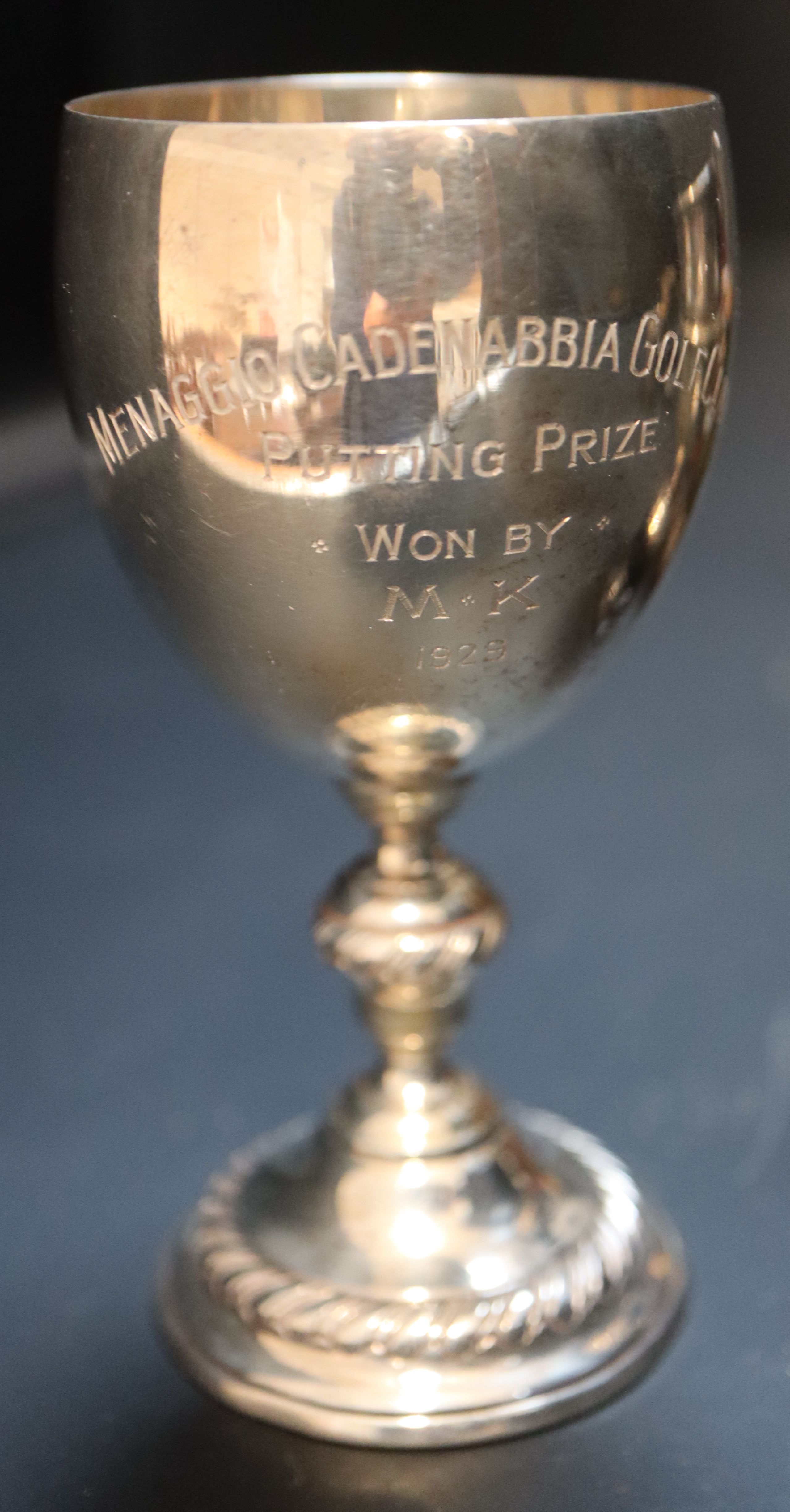 Two small silver trophy cups, largest 97mm, a modern silver gilt beaker and a group of assorted plated travelling beakers.